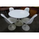 An Arkana style white laminate tulip shaped dining table and four chairs