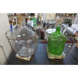 Two glass carboys in metal cages