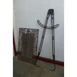 A pair of wrought iron animal calipers and a wrought iron door mat