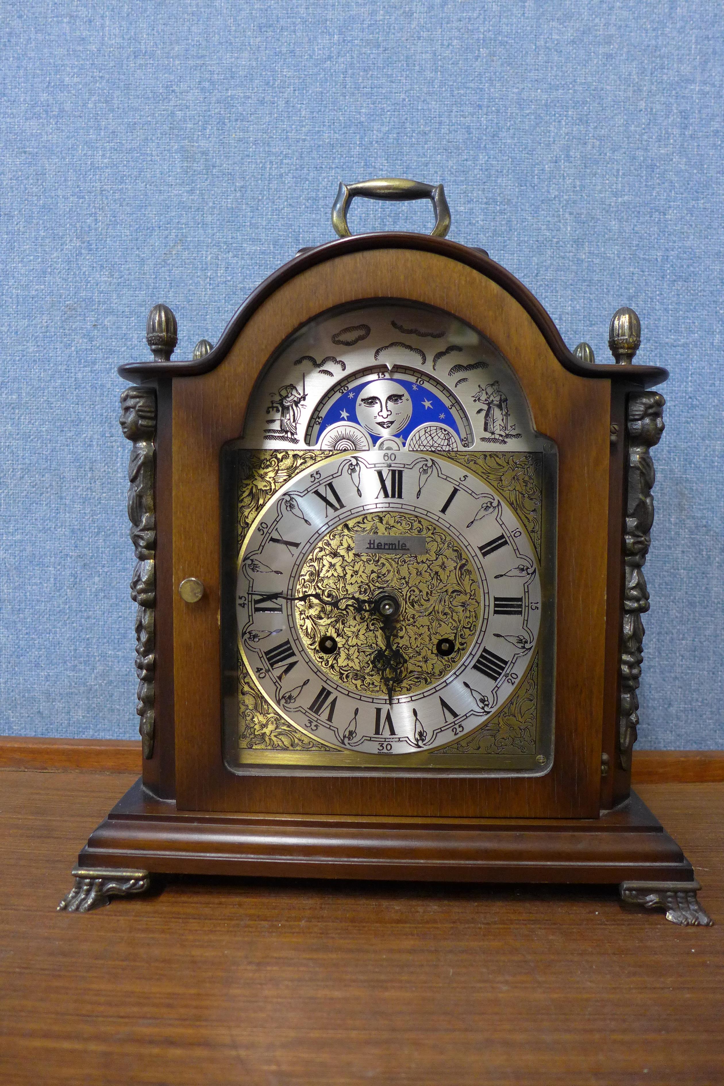 A German Hermle walnut mantle clock with moonphase rolling dial