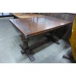 A 17th Century style carved oak extending refectory table