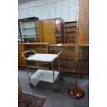 A teak standard lamp and a drinks trolley