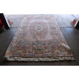 A Chinese pink ground rug, 280 x 189cms