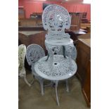 A painted cast aluminium garden table and three chairs