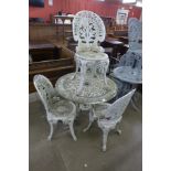 A painted cast aluminium garden table and four chairs