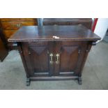 A Victorian Aesthetic Movement oak two door cupboard