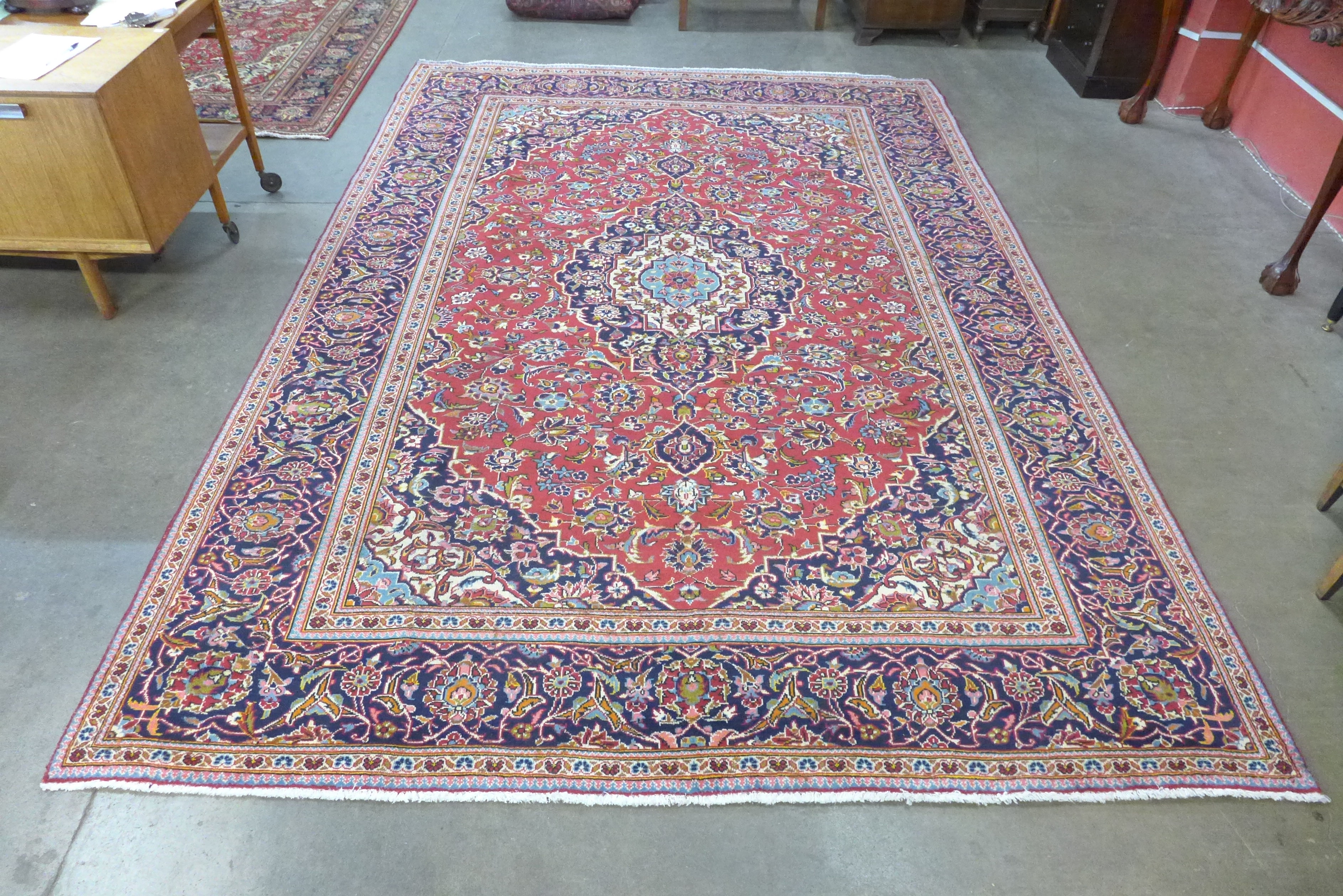 A Persian red ground Kashan rug, 363 x 249cms