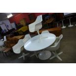 An Arkana white laminate tulip shaped table and six chairs, designed by Maurice Burke