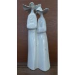 A Lladro figure of two nuns, 34cm