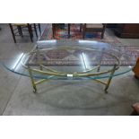 An Italian style brass and oval glass topped coffee table