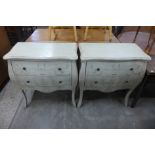 A pair of French style painted bombe shaped commodes