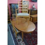 A teak extending dining table and four chairs