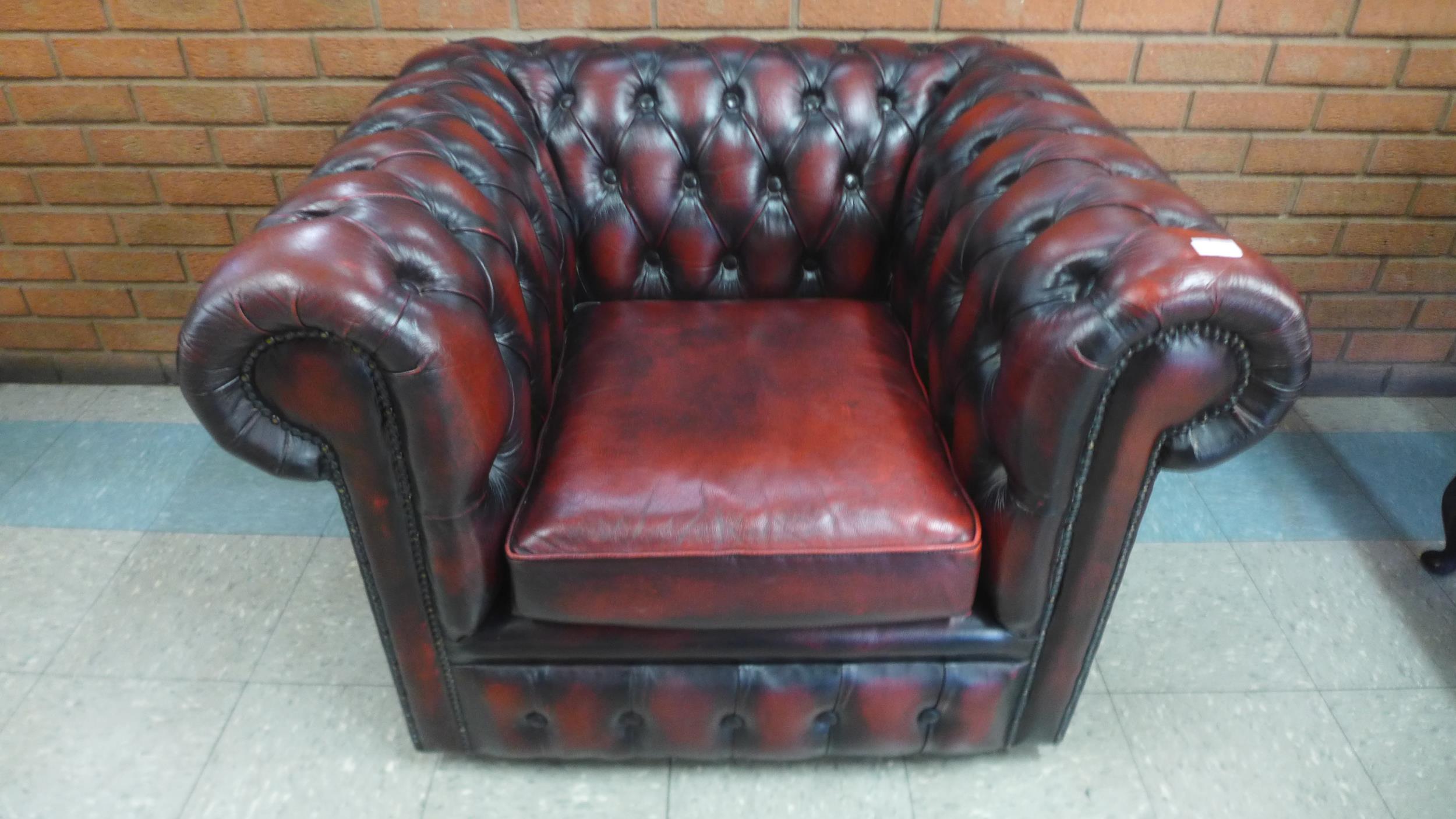 An oxblood red leather club chair