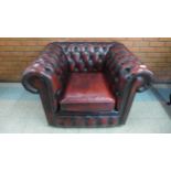 An oxblood red leather club chair