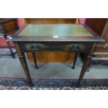 An Arts and Crafts oak and green leather topped single drawer writing table