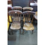 A Harlequin set of four Victorian elm and beech kitchen chairs