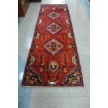 An eastern red ground runner rug, 305 x 105cns