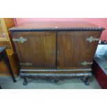 An Edward VII Chippendale Revival carved mahogany press cupboard