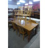 A pine two drawer farmhouse kitchen table and six beech chairs