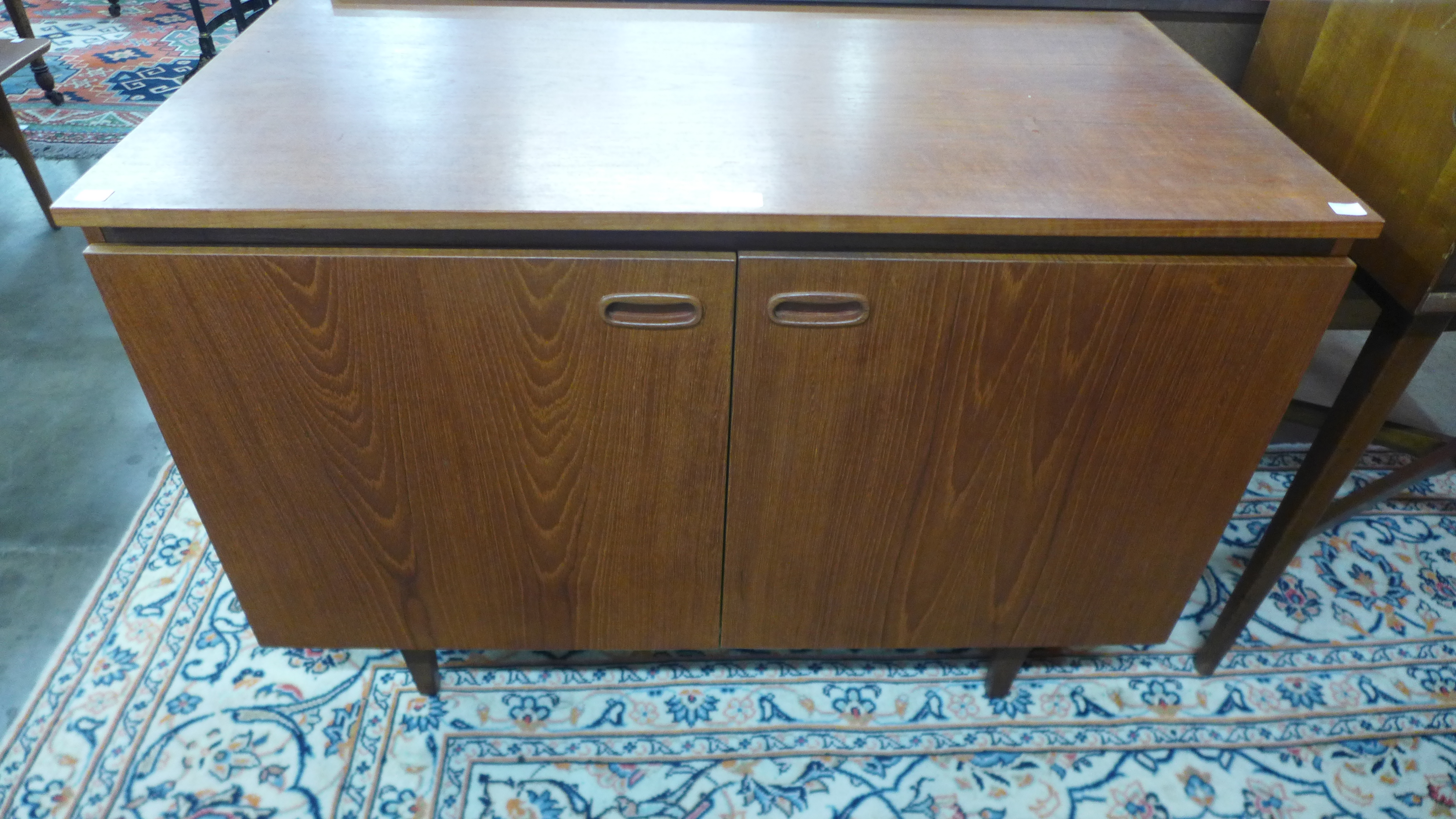 A Danish teak fitted two door music cabinet