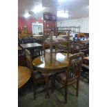 An oval oak dining table and four Arts and Crafts oak chairs