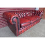 A red leather Chesterfield three seater sofa