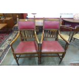 A pair of Arts and Crafts oak and red leather armchairs