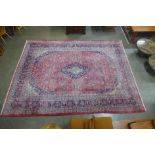 A Persian red ground Maghadh rug 392 x 292cms