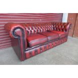 A red leather Chesterfield three seater sofa, a/f