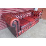 A red leather Chesterfield three seater sofa
