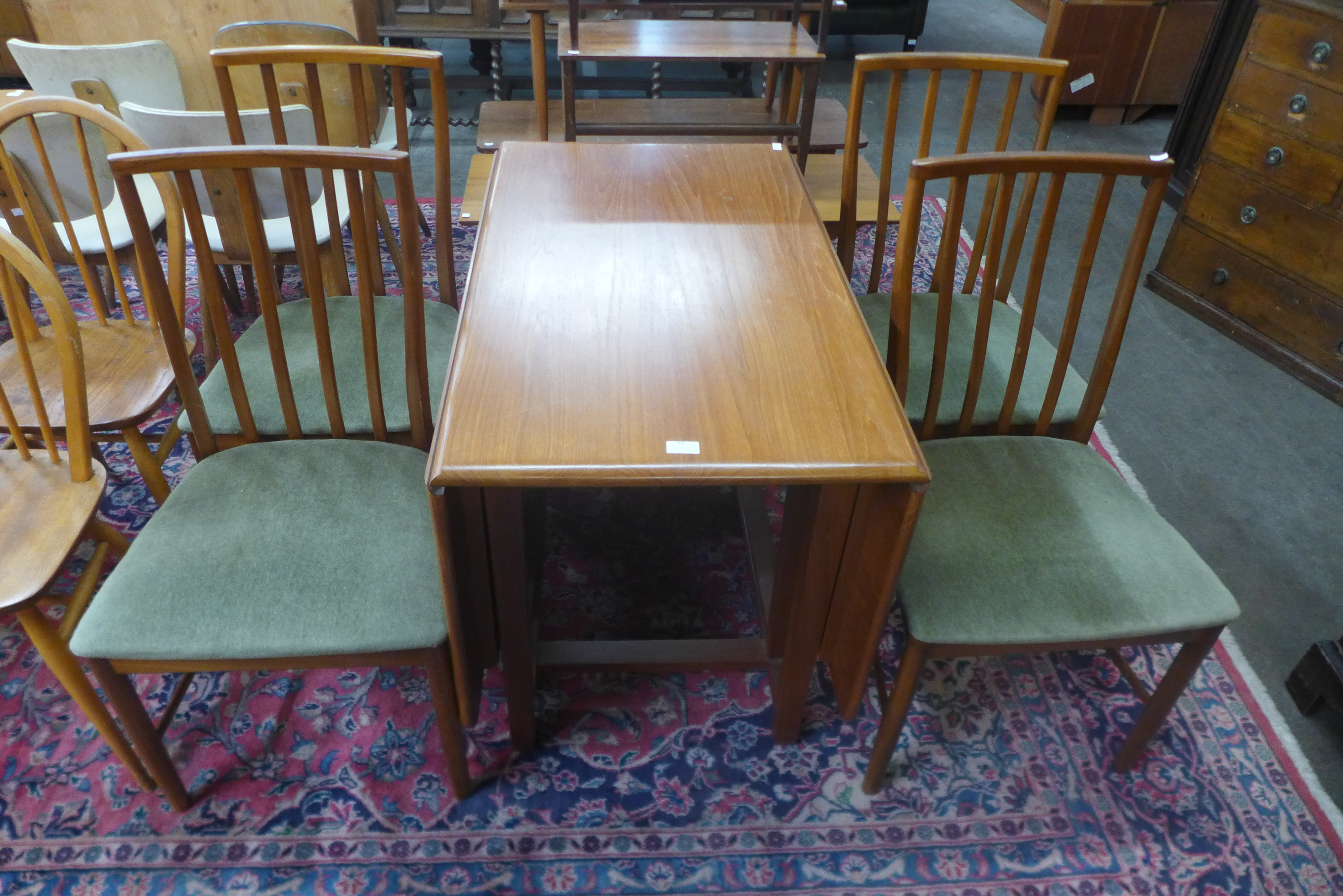 A teak drop leaf dining table and four McIntosh dining chairs