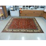 An early 20th Century Persian red ground Tabriz rug, 396 x 335cms