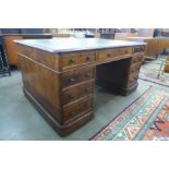 A Victorian oak and green leather topped partners library desk