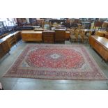 A Persian red ground rug, 398 x 300cms