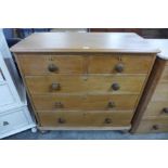 A Victorian waxed pine chest of drawers