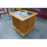 A teak and glass topped coffee table/magazine rack