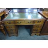 A yew wood and green leather topped pedestal desk (originally purchased from Brights of Nettlebed)