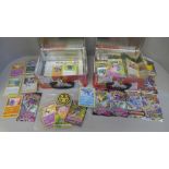 A collection of various Pokemon cards and coins, folders, keyrings, a poster, etc.