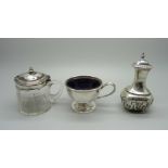 A silver pepperette, a silver mounted glass mustard and a silver salt with blue glass liner,