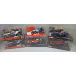 Six Formula 1 model racing cars, three SCX and three Carrera, boxed