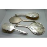 A silver backed mirror, two silver backed brushes, a/f, and a silver mirror back for scrap