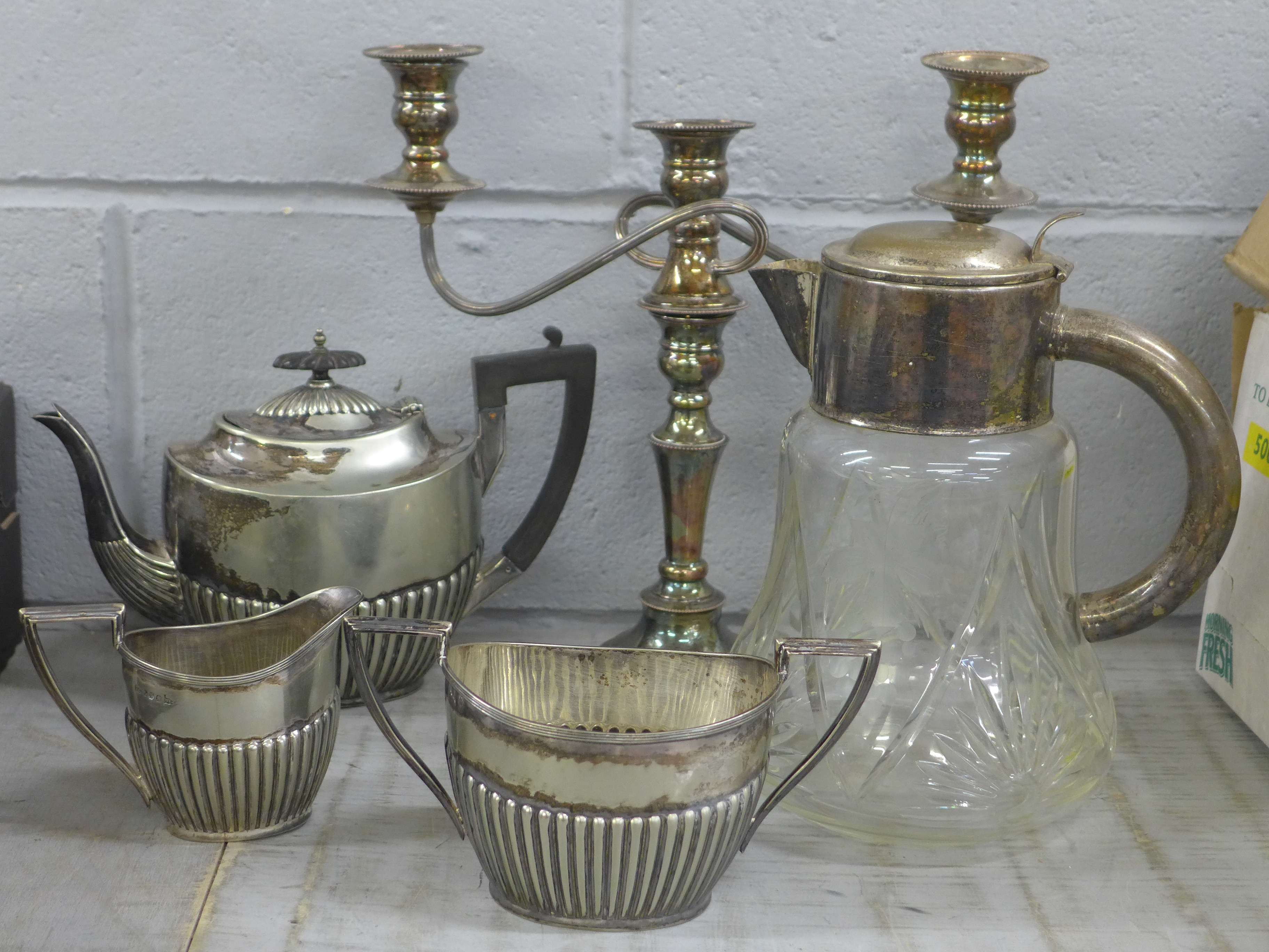 A collection of plated ware including a Walker & Hall teapot, sugar bowl and milk jug, and a