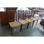 A set of four Danish teak and cord seated dining chairs