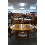 A teak extending dining table and six chairs