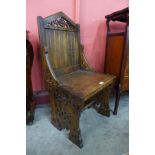 A Victorian Gothic Revival carved oak hall chair