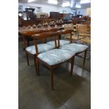 A set of four teak dining chairs