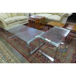 A chrome and glass topped coffee table with matching occasional table