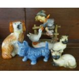 A West German Goebel figure, a Staffordshire dog, Sylvac dog and two cat figures