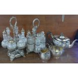 Two six-bottle cruets with plated stands and a silver plated three piece tea service
