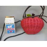 A Holly & Nic Snow White Apple limited edition bag and another bag in the form of a milk carton